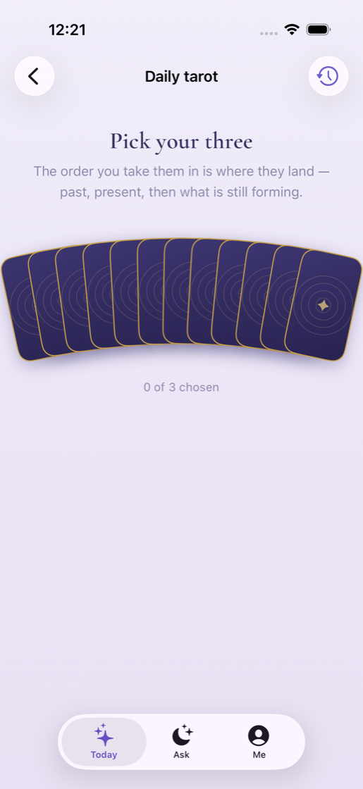 A fanned tarot spread waiting for three cards to be chosen.